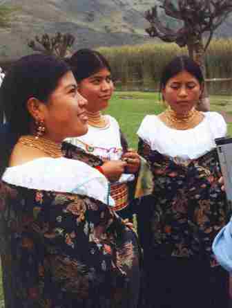 Three women outdoors in matching dresses