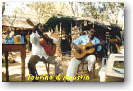 Two men playing guitar. Caption: Taurino & Houstin