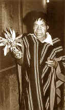 Sepia image of a man presenting a ceremonial object