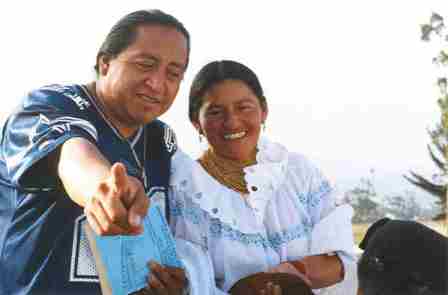 Man pointing at the camera and woman smiling